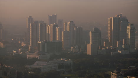 Slow-Motion-High-Altitude-Panning-Shot-Of-Manila-Bay-Towers-At-Morning-Sunrise