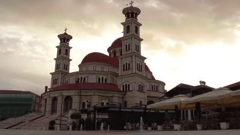 Cathedral-of-Korca-in-Albania-with-fountains-on-paved-square-at-cloudy-morning