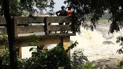 Pan-shot-revealing-a-person-watching-waterfall-at-Usri-Falls-in-Giridih,-Jharkhand,-India-on-Tuesday-6th-October,-2020