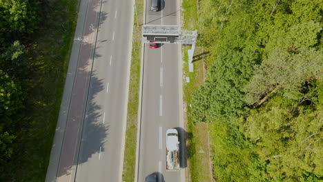 Two-Lane-Narrow-Road-Leading-To-Gdynia-Poland-At-The-Edge-Of-The-Witomino-Forest---aerial-shot