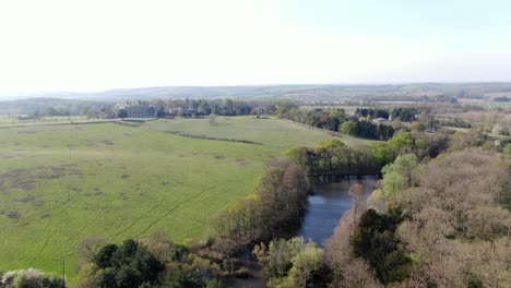 Large-Lake-Aerial-shot-on-Copped-hall-estate-lake-with-house-in-background-England-Essex