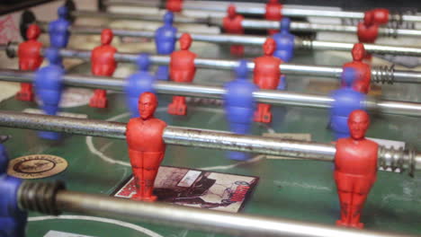Close-up-shot-of-people-playing-an-old-vintage-game-of-fussball