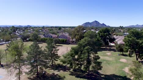 Drone-footage-of-Scottsdale-city-park,-tilt-down-from-church-cross-to-park