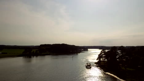Tilt-up-while-flying-over-a-recreational-boater-on-the-Tennessee-River-approaching-Concord-Park-in-Knoxville,-TN