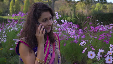 Young-Woman-Wearing-Sari-Talking-On-Mobile-Phone---Close-up