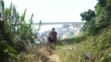 Wide-Shot-of-Woman-Walking-Towards-a-View-of-Porto-in-Slow-Motion