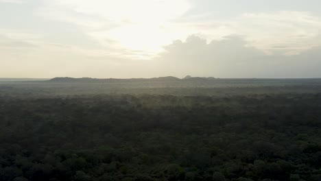 Sunrise-above-steam-filled-humid-jungle-in-Sri-Lanka-forest,-aerial