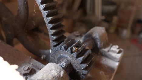 Old-knife-sharpening-tool-cogwheels-in-close-up-pan-view