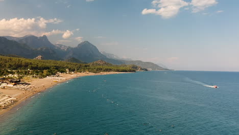 Aerial-drone-shot-of-the-ocean,-beach-and-mountain-coast-in-Antalya,-Kemer,-Turkey