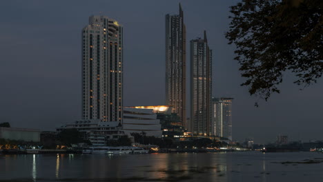 A-4K-night-to-day-time-lapse-of-dawn-at-IconSiam-Department-store,-Bangkok,-Thailand