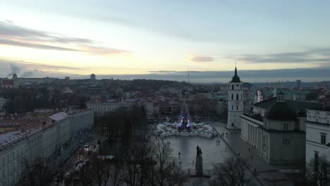 Drone-aerial-view-of-Vilnius-Cathedral-Square,-winter-sunset