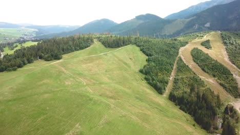 Forward-drone-shot-over-the-top-of-a-hill-in-Tatras,-Slovakia,-Europe