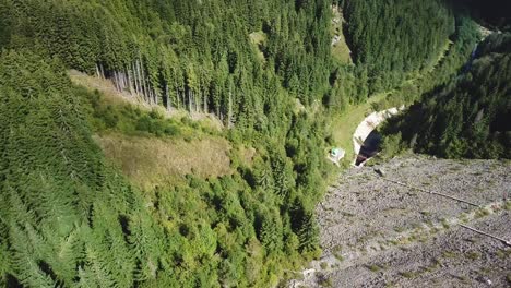 Vertical-panning-of-a-forward-drone-shot-over-a-dam-on-the-road-to-Transalpina-in-Romania