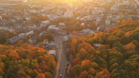 Drone-aerial-view-of-Kaunas-city,-during-autumn-sunset
