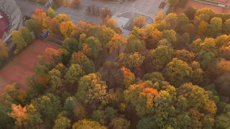 Drone-aerial-view-of-Kaunas-city,-during-autumn-sunset
