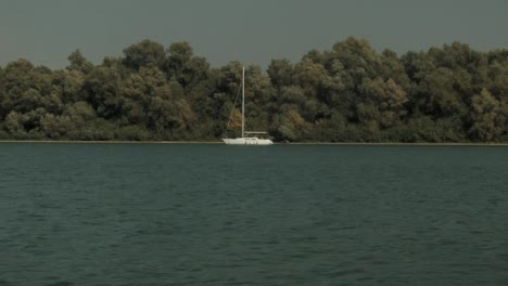 An-HD-static-shot-of-a-white-yacht-anchored-by-a-river-island-in-Belgrade