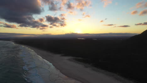 Beautiful-drone-shot-of-sunrise-over-ocean-near-South-West-Rocks-Australia