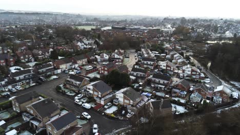 Snowy-aerial-village-residential-neighbourhood-Winter-frozen-North-West-houses-and-roads-reversing-shot