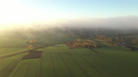 Drone-aerial-view-of-foggy-morning-in-Kaunas-county,-Lithuania