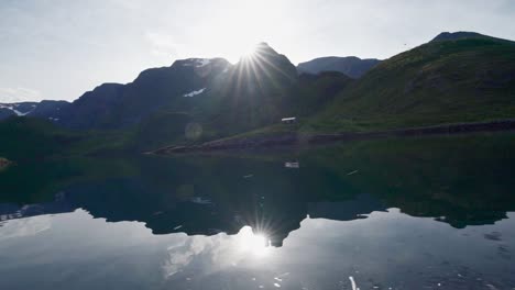 Reflection-Of-Mountain-In-River-Under-Warm-Weather-In-Norway---View-From-A-Sailing-Boat