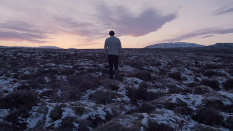 Lonely-man-walking-in-vast-Scandinavian-landscape-Slow-Motion
