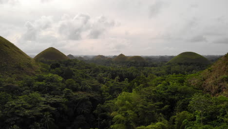 4K-Aerial-Flyover-The-Chocolate-Hills,-Just-Above-The-Jungle