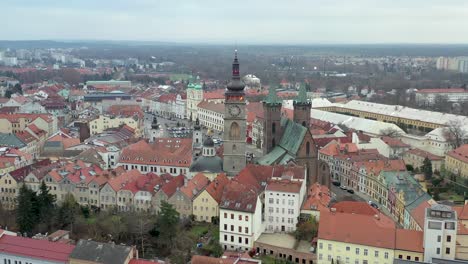 Aerial-View-of-Clock-Tower-and-Gothic-Cathedral-Surrounded-by-Buildings-in-Hradec-Kralove,-Czech-Republic