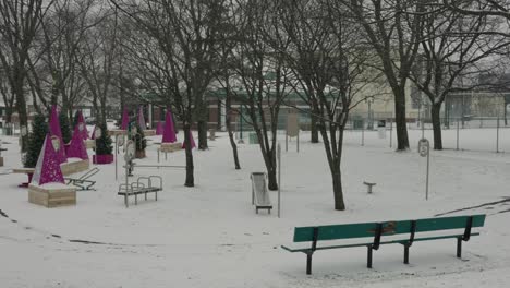 Calm-Empty-Park-Bench-and-Purple-Cones-Fitness-Apparatus-Outside-in-Cold-Winter-Snow