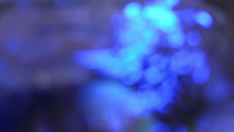out-of-focus-shot-of-blue-light-reflection-on-wavy-water-surface