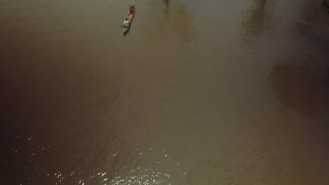 Aerial-view-of-an-indigenous-canoe-crossing-the-Orinoco-River