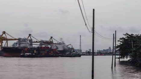 A-4K-motion-time-lapse-of-container-ships-at-Bangkok-Port,-Thailand-shot-at-dawn