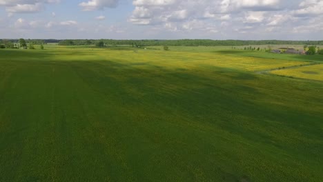 Country-side-panoramic-landscape-in-summer-time-from-above-and-ground-with-hay-rolls-and-roads