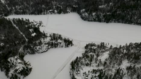 Aerial-pan-right-of-a-frozen-Canadian-lake-in-Canada's-northern-boreal-forest