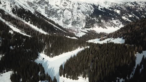 Aerial,-beautiful-woods-and-a-valley-under-the-snow-in-mountains,-Austria,-Tirol