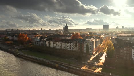 Revealing-drone-shot-of-Mainz-the-city-of-Biontech-vaccine-against-Corona-Covid-19-in-Germany-from-an-aerial-view-in-golden-fall-light-and-dramatic-Sky