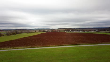 Aerial-over-a-farm-field-in-rural-Hamburg,-Pennsylvania