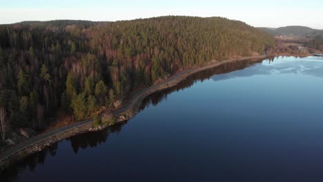 Aerial-Shot-Of-Pristine-Forest-Landscape-Surrounding-Tranquil-Lake,-Beautiful-Destination-In-Sweden