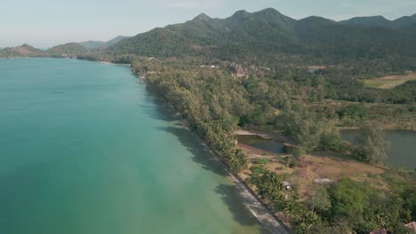 Aerial-view-of-coastline-and-resorts-in-a-lagoon-coastal-beach-koh-chang,-Thailand