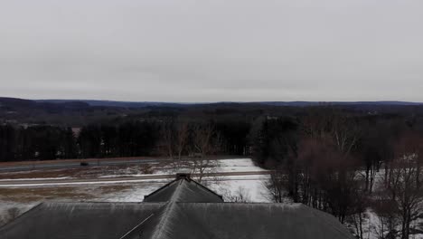 Drone-shot-flying-past-a-decaying-cupola-at-the-abandoned-Fairfield-Hills-Hospital-asylum-in-Newtown,-Connecticut