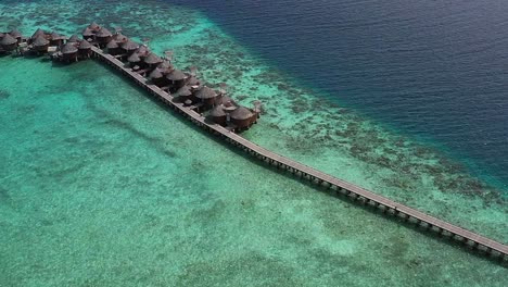 Aerial-view-of-beautiful-Maldives-island-over-water-villa-bungalows,-Nika-Island