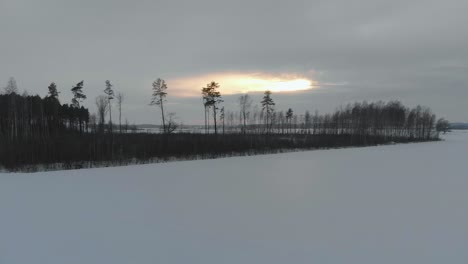Amazing-view-of-winter-white-landscape-in-Latvia,-Kurzeme,-drone-flying-sideways