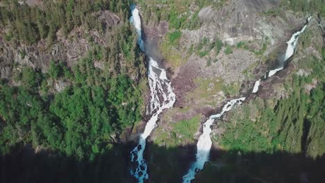 Tilt-down-drone-shot-over-two-large-waterfalls-in-Norway,-shot-in-4K