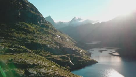 Panning-drone-shot-of-a-rocky-hill-over-a-lake-in-Lofoten