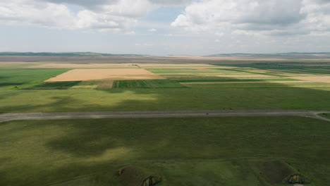 Car-driving-on-Shiraki-military-airfield-runway-in-georgian-fields