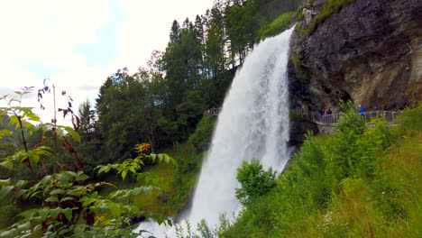 Raging-Steinsdalsfossen-Waterfall-Steine,-Norway-static-wide-framed-from-side,-then-push-in,-4k-ProRezHQ