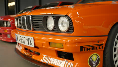 Pirelli-and-Jägermeister-promotional-branding-on-orange-BMW-e30-at-Barcelona-classic-car-fan-meeting