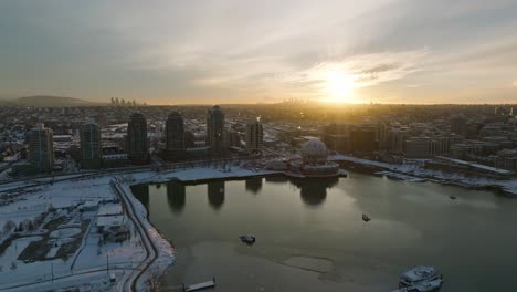 Vancouver-Drone-Aerial-Moving-shot-of-the-ASTC-Science-World-globe-building-covered-in-snow---Canada