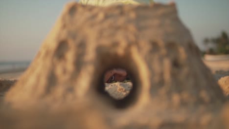 Mysterious-indian-woman's-eye-watching-through-a-sand-pyramid-hole