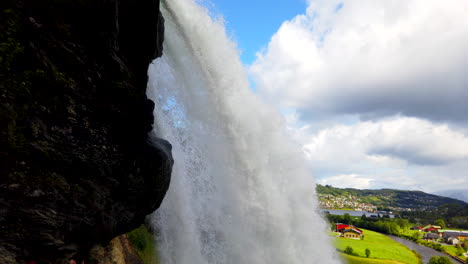 Steinsdalsfossen-Waterfall-Steine,-Norway-quick-tilt-up-from-behind-falls-2-ProRezHQ-4k