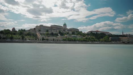 Boat-ride-through-Danube,-summer-afternoon,-budacastle-in-the-distance
